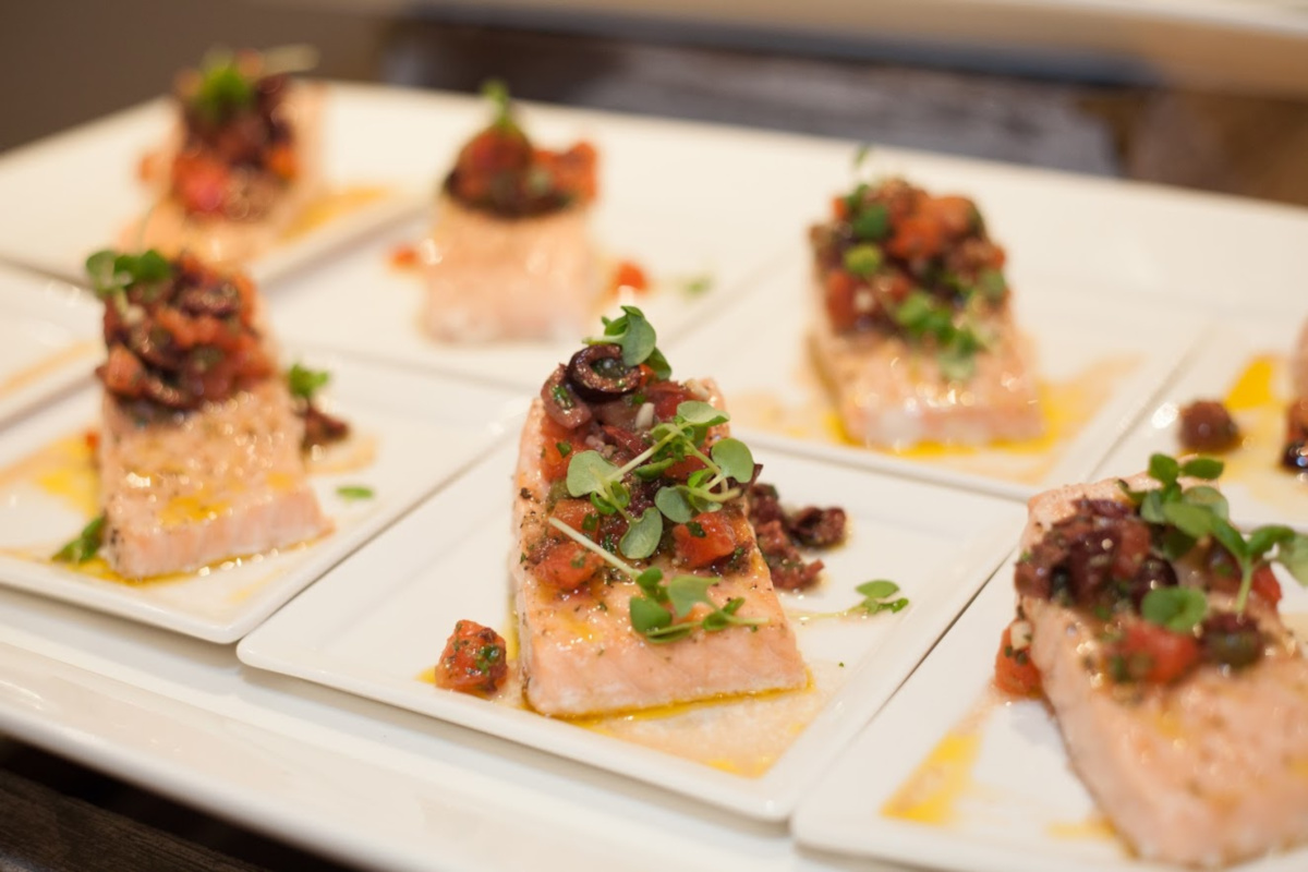 a row of fish steaks with sides