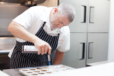 Chef searing desserts