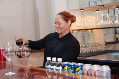 Staff member pouring a glass of wine