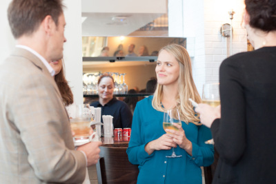 People mingling with drinks in hands